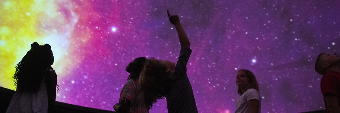 Science Center image showing a group of children enjoying the space installation